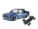 Dark blue E30RC drift car body with Pandem decals alongside its black RC chassis on a white background