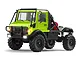 Green MN Model Unimog RC rock crawler truck featuring a black roll cage, large off-road tires, and lit headlights against a white background.