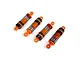 Set of four orange and black RC shock absorbers with metal coil springs on a white background.