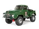 A green 1955 Ford F-100 RC rock crawler truck by Axial, shown from a front three-quarter angle on a white background.