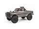 A silver Axial SCX24 1967 Chevrolet C10 RC rock crawler truck viewed from a three-quarter angle against a white background.