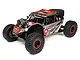 Losi Super Rock Rey V2 1/6 scale RC rock racer in grey and red livery, featuring off-road tires, roll cage, and LED light bars on a white background.