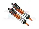 A pair of GPM Racing orange and black aluminium piggyback shock absorbers for RC cars, shown against a white background with a faint watermark.