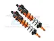 A pair of GPM Racing orange and black aluminium piggyback shock absorbers for RC cars against a white background.