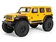 A yellow Axial SCX24 2019 Jeep Wrangler JLU RC rock crawler shown from a front three-quarter angle against a white background.