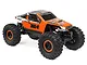 Axial AX24 XC-1 1/24 scale RC rock crawler in orange and black, featuring large off-road tires and detailed body graphics.