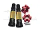 GPM Racing hardened steel CVD axle shafts with gold sleeves, red aluminium wheel hexes, and two small metal pins on a white background.