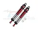 Two GPM Racing red and black aluminium adjustable RC shock absorbers with two small white plastic spacers on a white background.