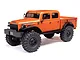 Orange Axial SCX24 Dodge Power Wagon RC rock crawler truck on a white background.