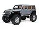 A studio shot of the grey Axial SCX24 Jeep Wrangler JLU 1/24 scale RC rock crawler, showing the side and front profile against a white background.