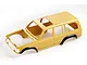 A yellow FMS Land Cruiser 80 RC car body shell with black wheel arches, viewed from a high angle against a white background.