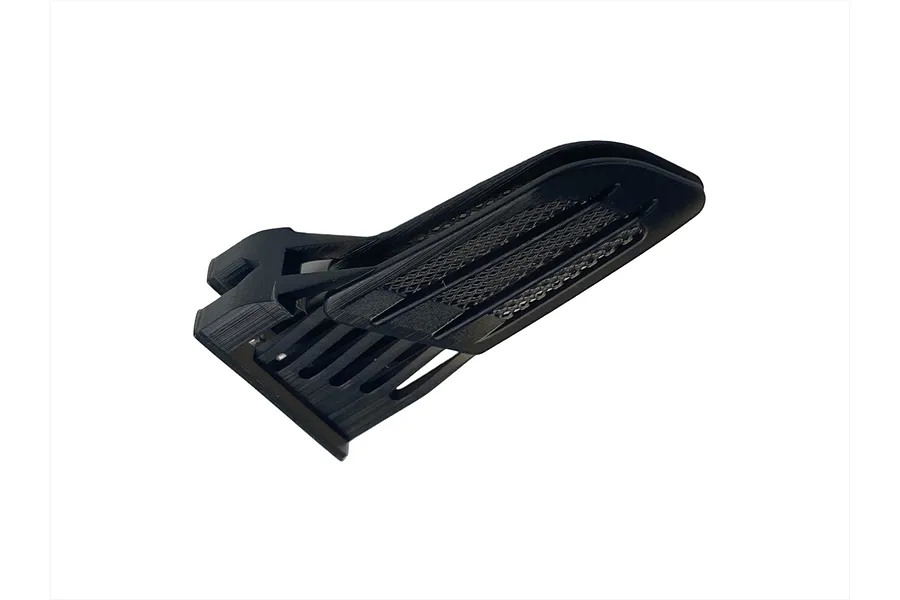 A black 3D-printed RC car fender duct accessory with a mesh grille detail on a white background.