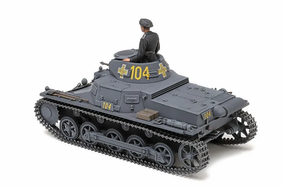 A completed 1/35 scale Tamiya German Panzerkampfwagen I Ausf. B model tank with a crew figure in the turret, painted in grey with yellow 104 markings.