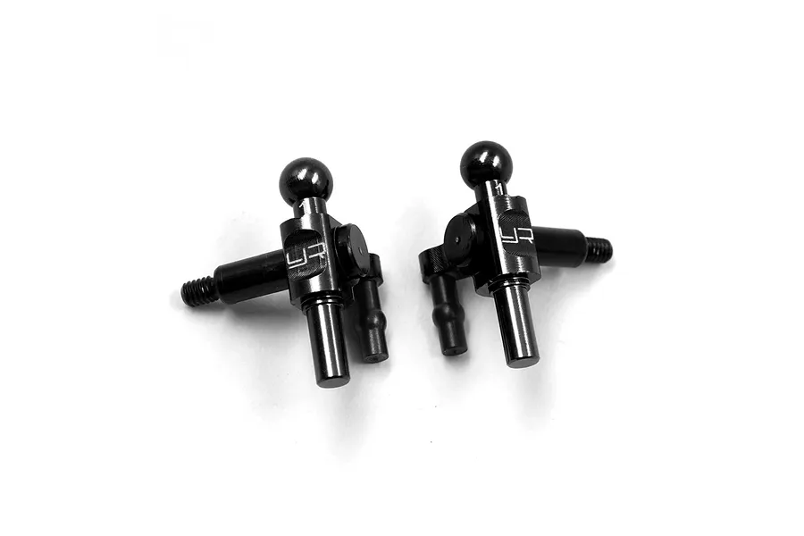Two black anodized aluminium Yeah Racing steering knuckles with ball studs, viewed from above against a white background.