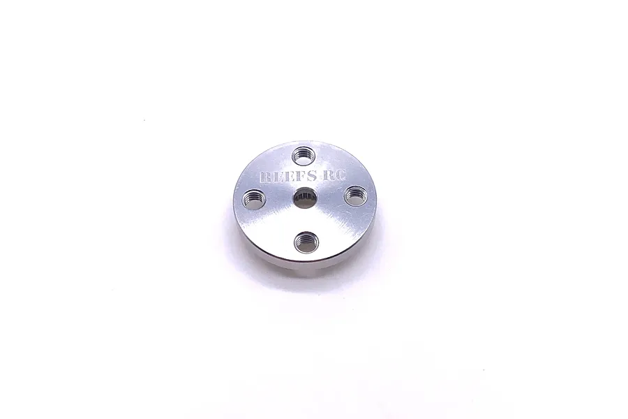 A silver round aluminium servo horn by Reefs RC with four mounting holes and a central 25T spline, isolated on a white background.