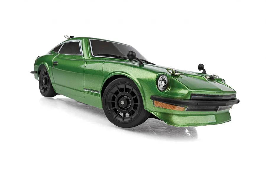 A green Team Associated SR27 Datsun 240Z RC car viewed from a low front-three-quarter angle against a white background.