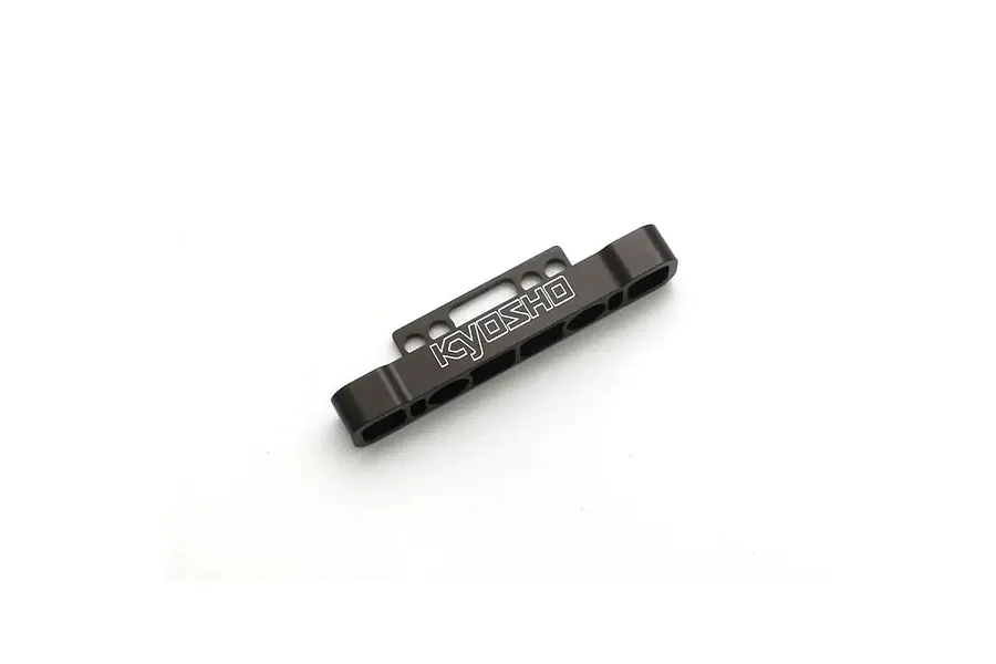 A gunmetal grey Kyosho aluminium rear lower suspension brace for RC cars, featuring a machined design with the Kyosho logo engraved on the front.