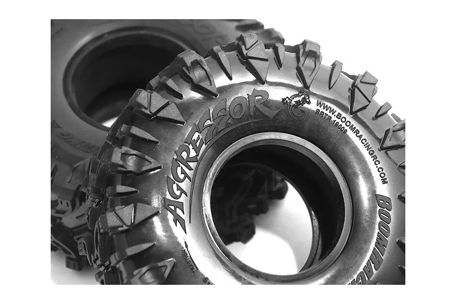 Two black Boom Racing 1.9 inch Aggressor crawling tyres with aggressive tread patterns and embossed branding on a white background.