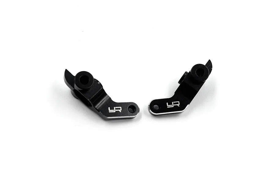 Two black aluminium steering hubs for RC cars by Yeah Racing, featuring the YR logo engraved on the side.