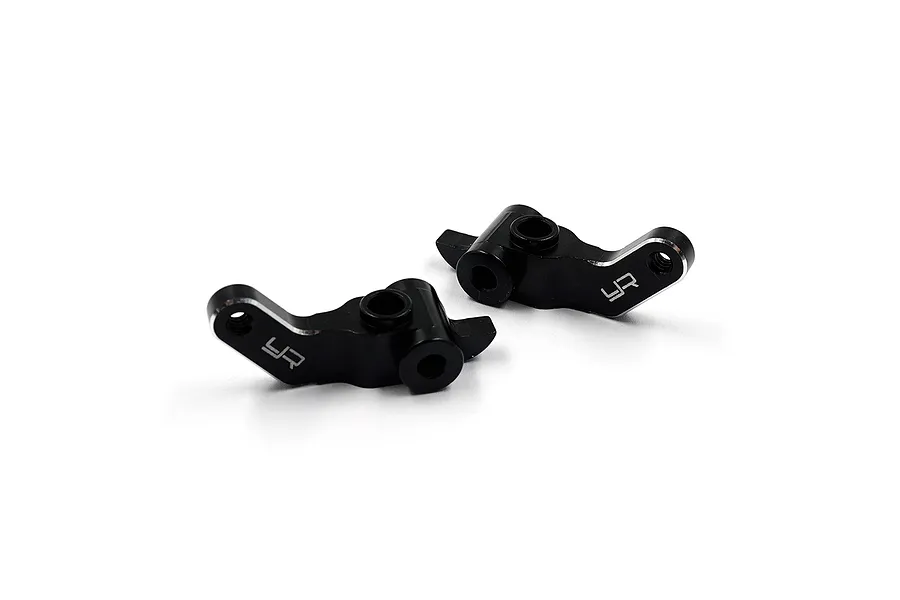 Two black anodized aluminium RC steering hubs from Yeah Racing, featuring a machined finish and the YR logo.