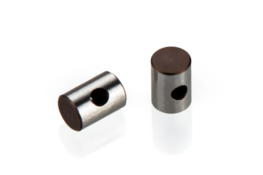 Two small cylindrical metal RC driveshaft studs with a cross-drilled hole, shown against a white background.