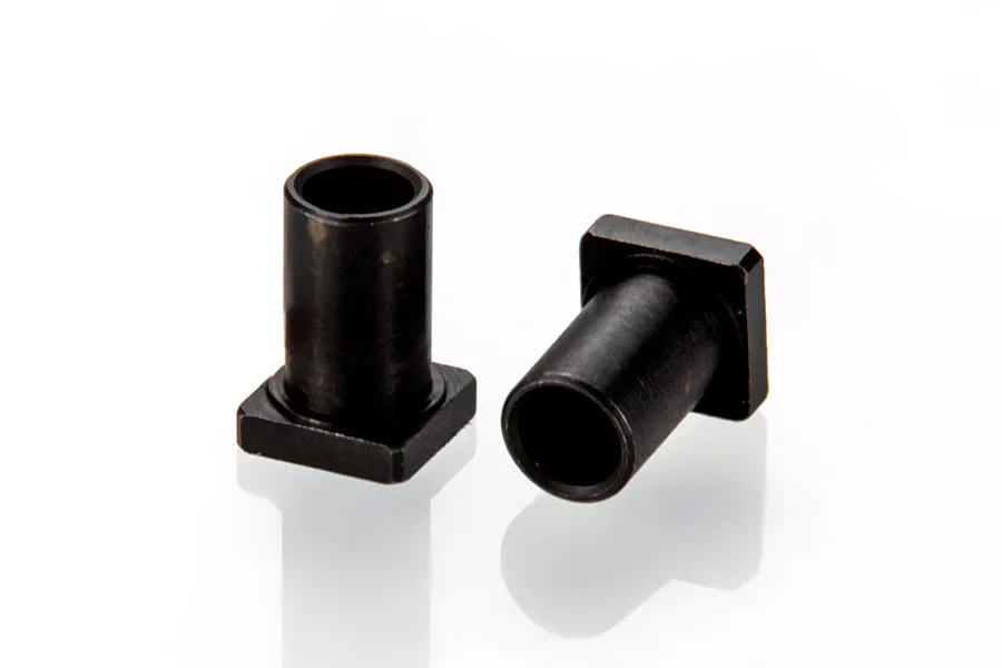 Two black metal RC rocker arm sleeves with a cylindrical body and a square base, isolated on a white background.
