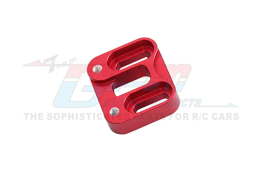 A red anodized aluminium RC car part with three elongated slots and two threaded mounting holes, viewed from an angle against a white background.