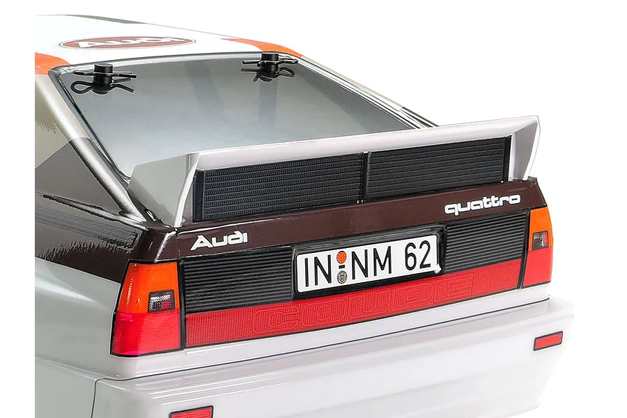 Rear view of a Tamiya Audi Quattro A2 RC car body shell showing the spoiler, taillights, and license plate.