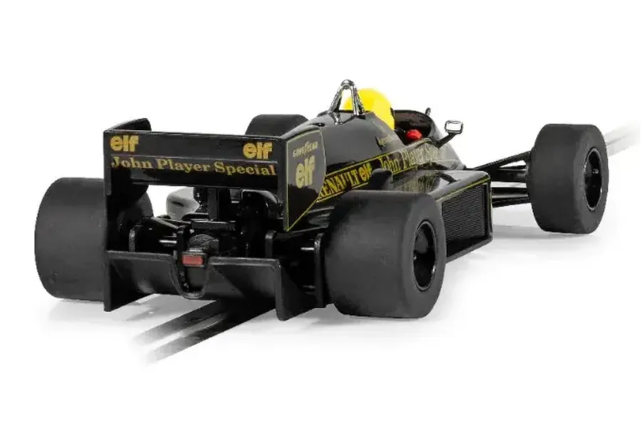 Rear three-quarter view of a black Scalextric 1/32 scale Lotus 98T Ayrton Senna slot car with gold John Player Special branding on a track.