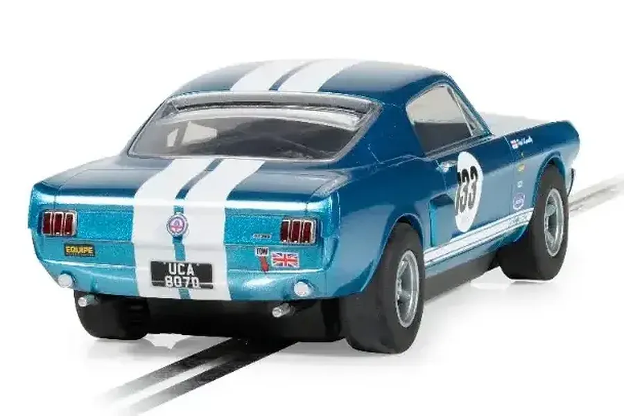 Rear three-quarter view of a metallic blue Scalextric Shelby Mustang GT350 slot car with white racing stripes and number 133 on the door.