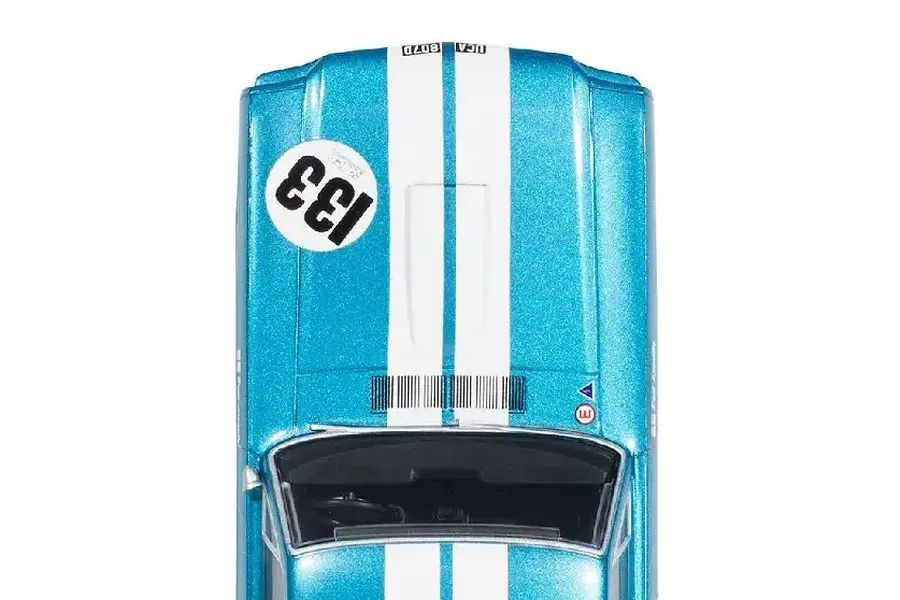 Top-down view of a metallic blue Scalextric Shelby Mustang GT350 slot car with white racing stripes and the number 133 on the hood.