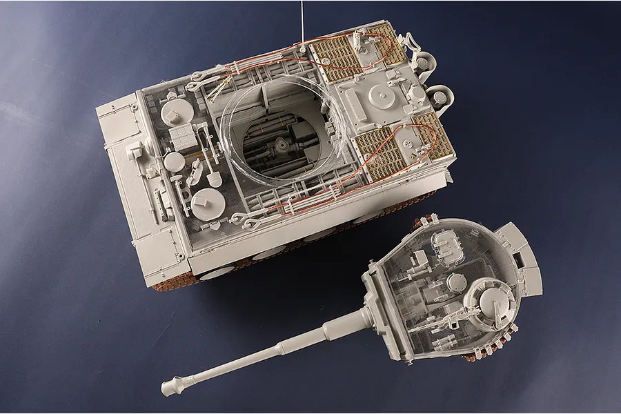Top-down view of a 1/16 scale Tiger I tank model kit with a transparent turret and hull section showing internal details.