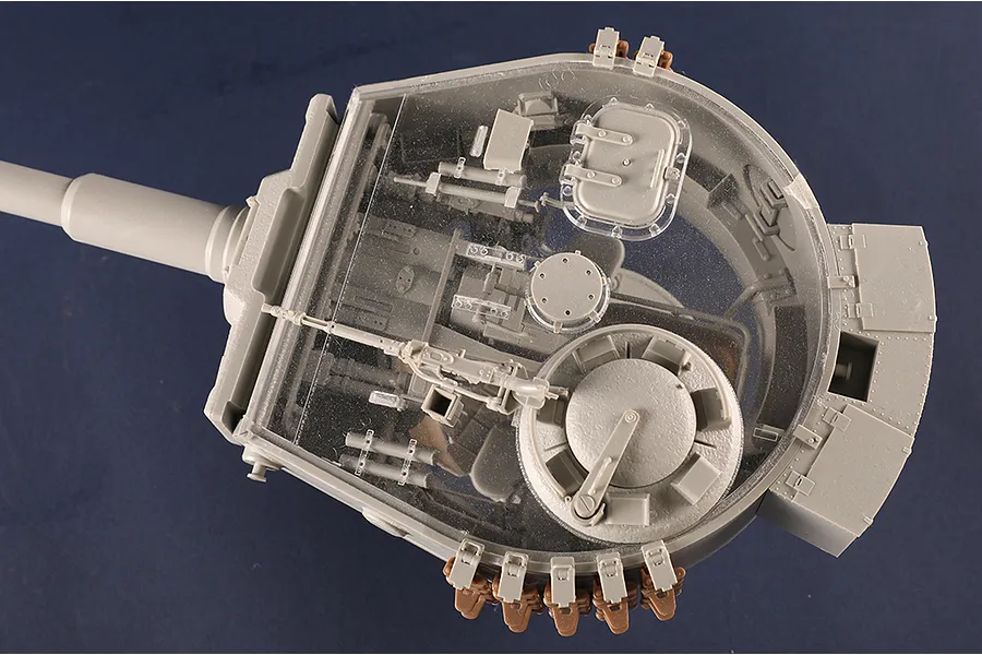 Top-down view of a 1/16 scale Tiger I tank turret model with a clear plastic roof showing internal details and a grey gun barrel.