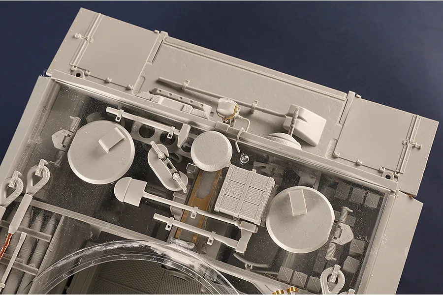 Top-down view of a 1/16 scale plastic model tank hull showing internal details through a clear top panel.