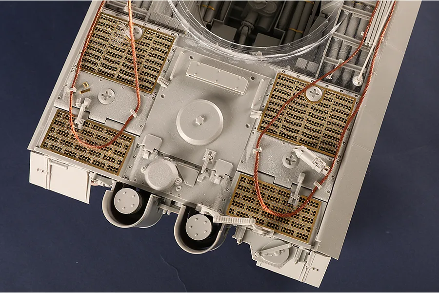 Top-down view of a 1/16 scale Tiger I tank model showing engine deck details, photo-etched metal grilles, and copper tow cables.