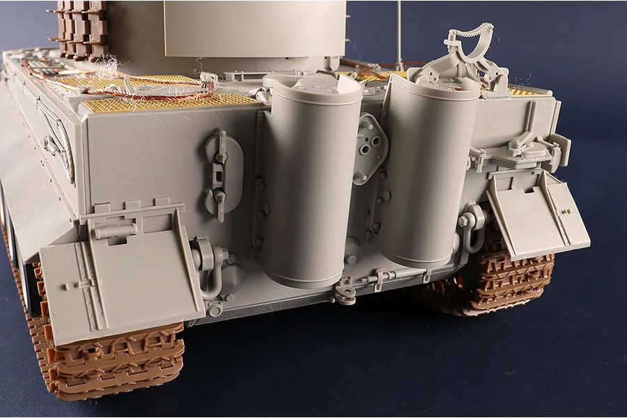 Rear view of an unpainted 1/16 scale Tiger I tank model kit showing engine deck details, exhaust pipes, and tracks.