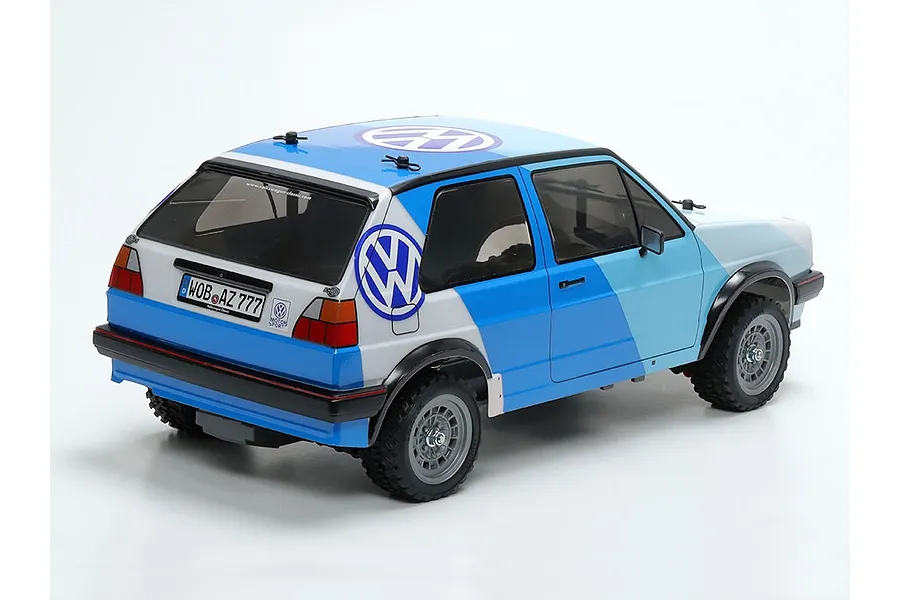 Rear three-quarter view of a Tamiya 1/10 scale RC Volkswagen Golf MK2 GTI rally car with blue and white livery on a white background.