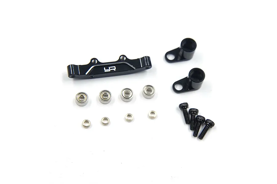 A Yeah Racing black aluminium steering bell crank and drag link assembly kit with bearings, screws, and spacers on a white background.