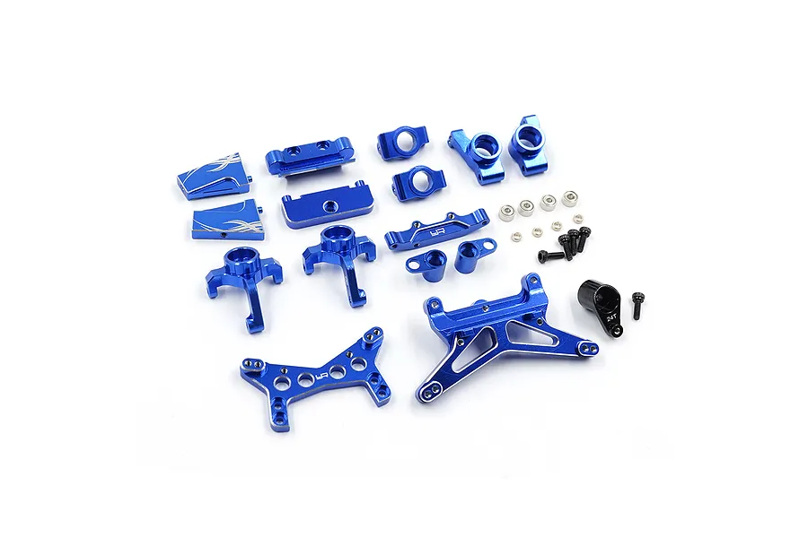 A collection of dark blue anodized aluminium RC car upgrade parts including suspension arms, steering knuckles, and shock towers.