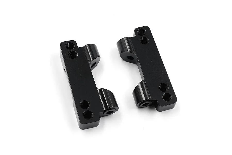 Two black anodized aluminium rear lower suspension arm mounts for RC cars, shown from an angled top-down perspective on a white background.