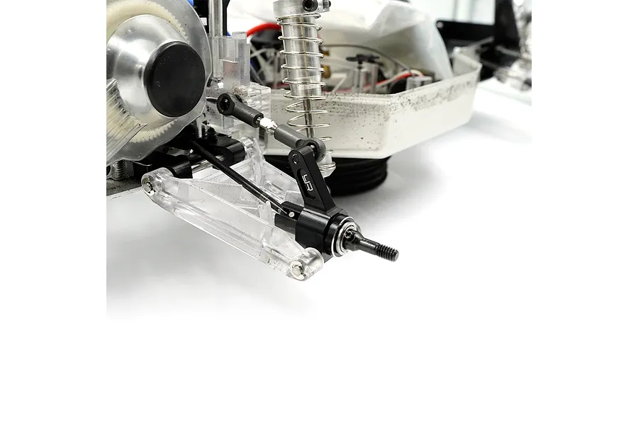 A close-up of a black aluminium rear hub installed on an RC car chassis, featuring the Yeah Racing logo.