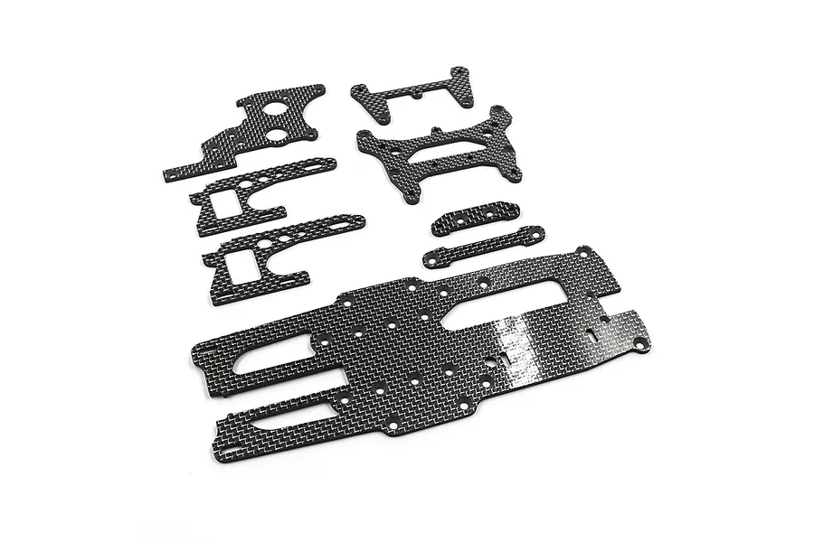 A set of flat carbon fiber RC chassis upgrade parts arranged on a white background.