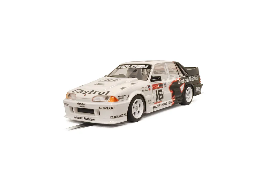 A 1/32 scale Scalextric slot car model of the 1990 Holden VL Commodore Group A race car, featuring white and black livery with number 16.