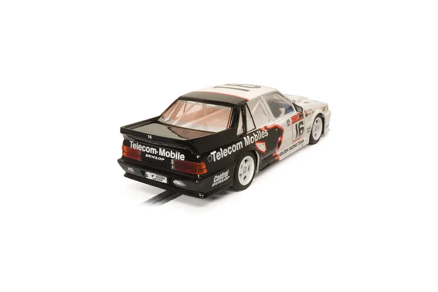 A 1/32 scale Scalextric Holden VL Commodore slot car in Telecom Mobile racing livery, viewed from the rear three-quarter angle.