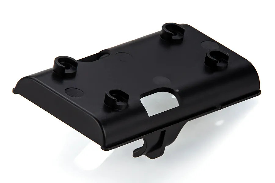 A black plastic battery holder component for an RC boat, featuring mounting clips and a rectangular base.