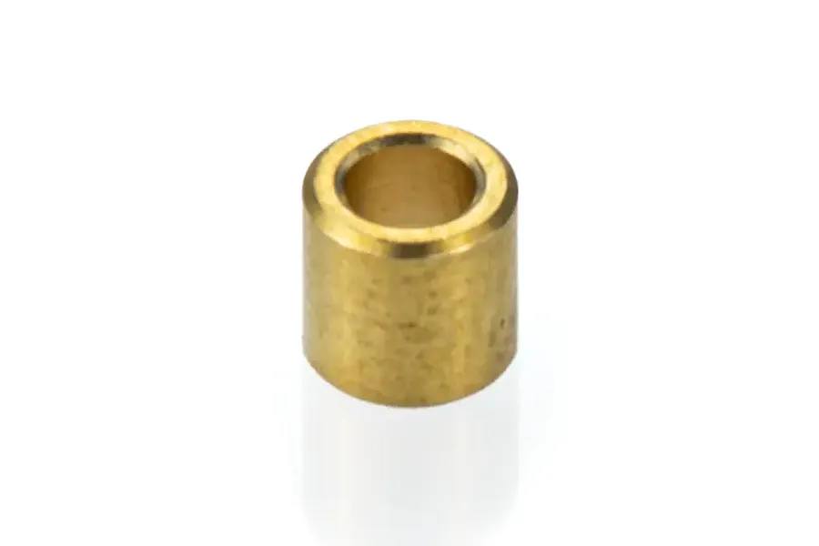 A single small cylindrical copper or brass bushing for an RC boat, shown against a white background.