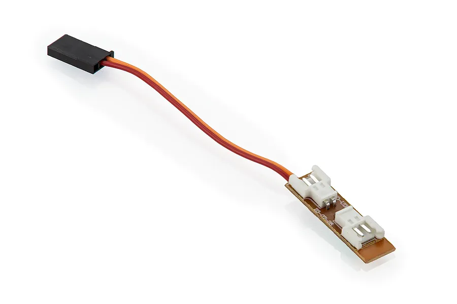 UDI RC LED light switching board with a small circuit board, two white connectors, and a red and orange wire leading to a black servo-style plug.