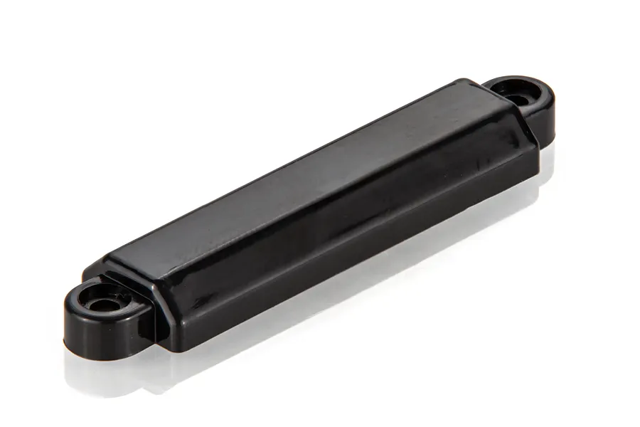 A black, rectangular UDI RC counterweight iron press spare part for an RC boat, shown on a white background.