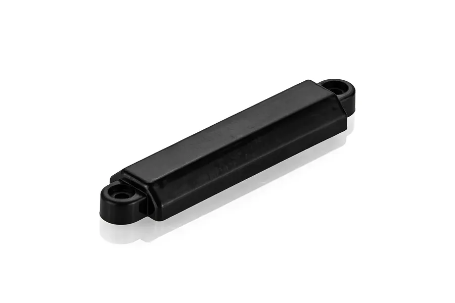 A black, rectangular UDI RC counterweight iron press spare part with mounting holes on each end, isolated on a white background.