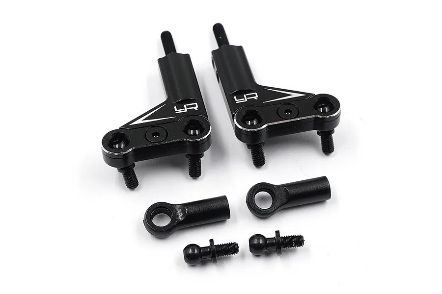 A pair of black aluminium RC suspension arms with associated ball ends and mounting hardware on a white background.